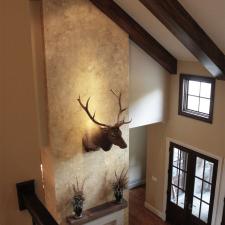Beautiful wall color and feature wall plaster faux design and faux wood ceiling beams